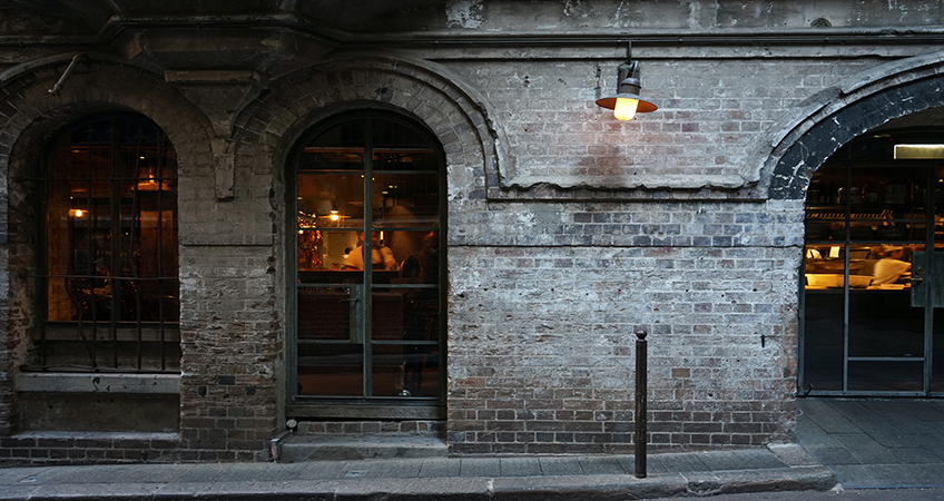 Sydney's industrial past features masonry arches, as seen in this alleyway, a motif reinterpreted in the office building proposed for Green Square. Image credit: Photo by Rose Lamond on Unsplash
