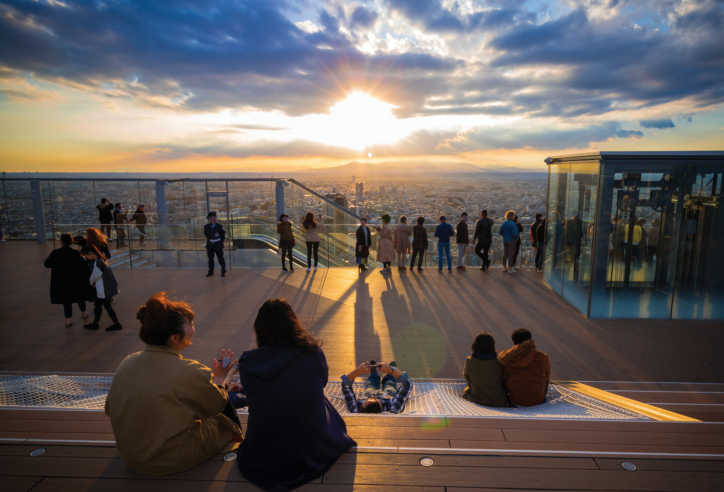 Figure 16. The rooftop of Shibuya Sky, Tokyo has been designed to provide patrons with a variety of viewing experiences of the city of Tokyo. It includes seating areas, lounges, small bars/food concessions and numerous photo opportunities. The feeling is spacious and without pressure. The tickets are timed to prevent overcrowding to maximize the experience. © Kakidai (cc by-sa)