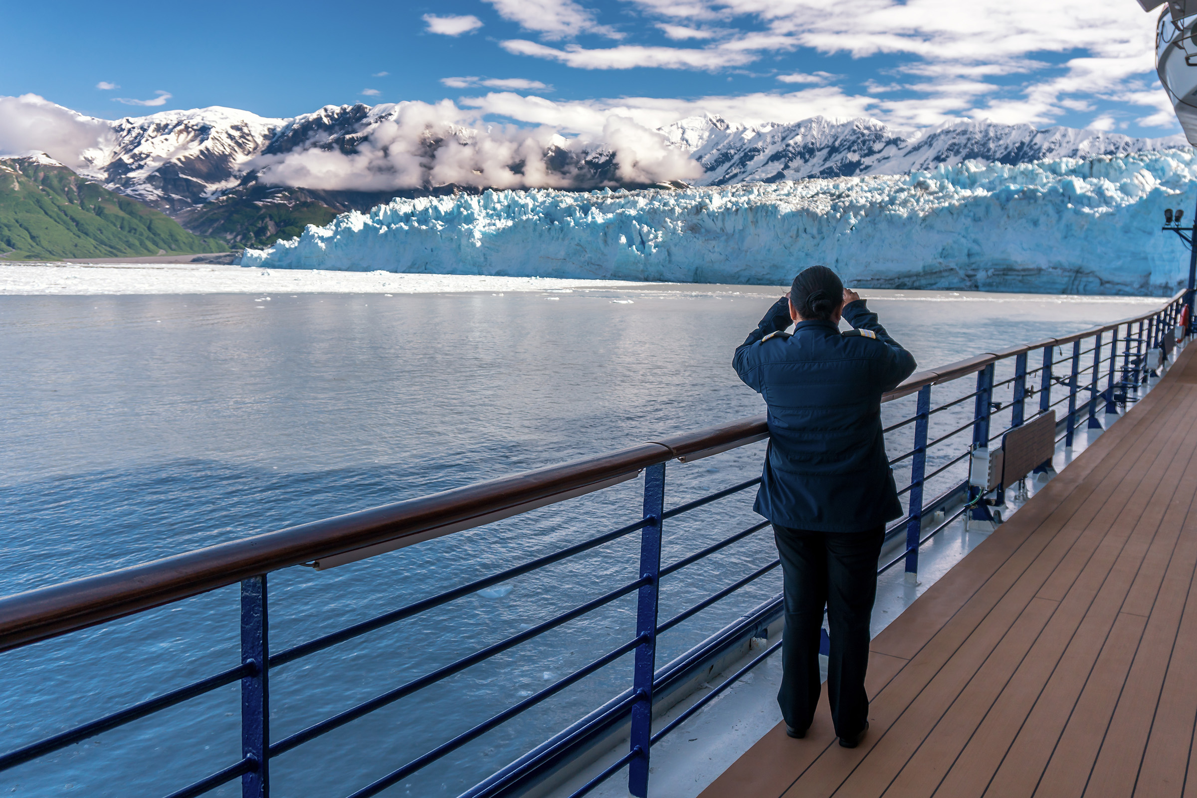 Woman looking at Hubbard Glacier from cruise ship