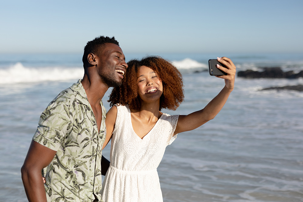Couple taking selfie on beach