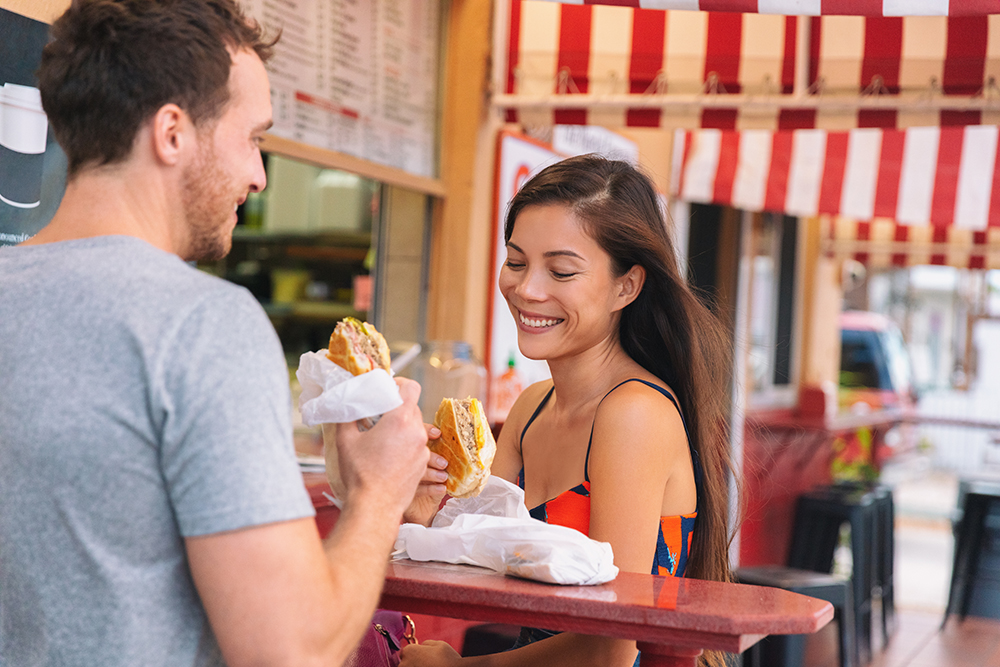 Couple eating Cuban sandwiches in Miami