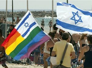 Gay Oasis:
 Israelis carry flags during last year?s gay pride parade in Tel Aviv.				