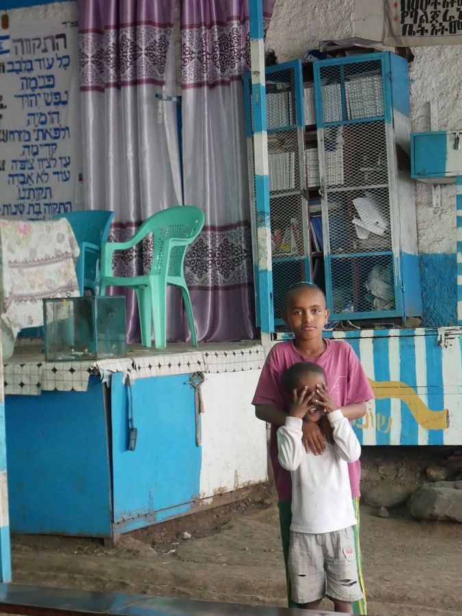 Ethiopian Jewish children in front of the ark in synagogue.