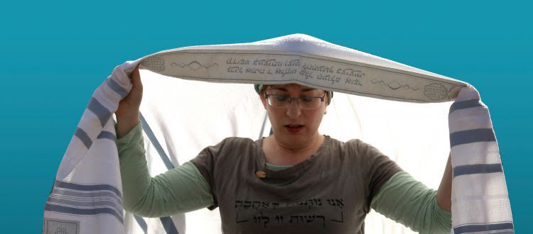 Woman praying with a tallit