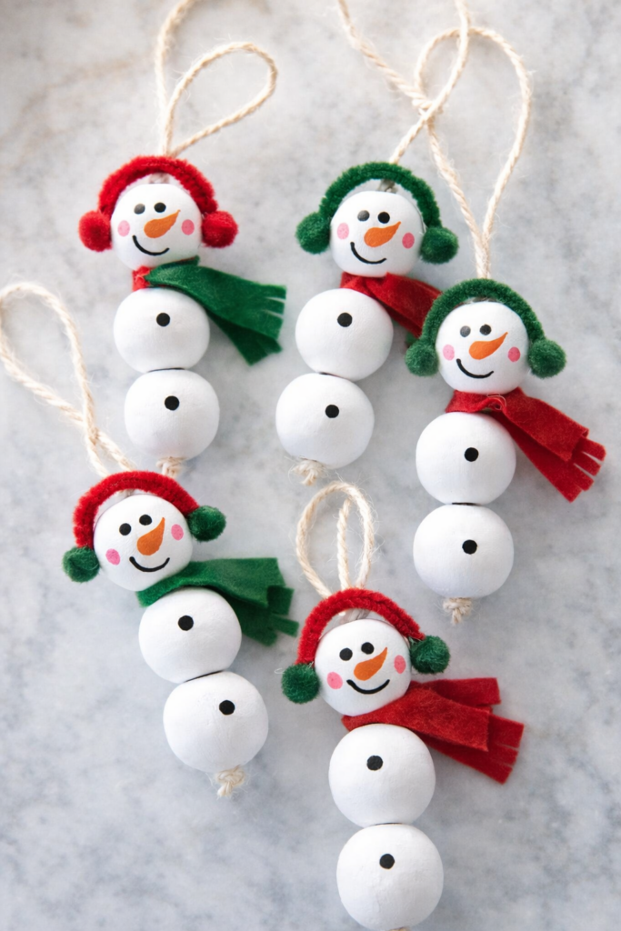 Easy winter craft showing handmade beaded snowmen ornaments