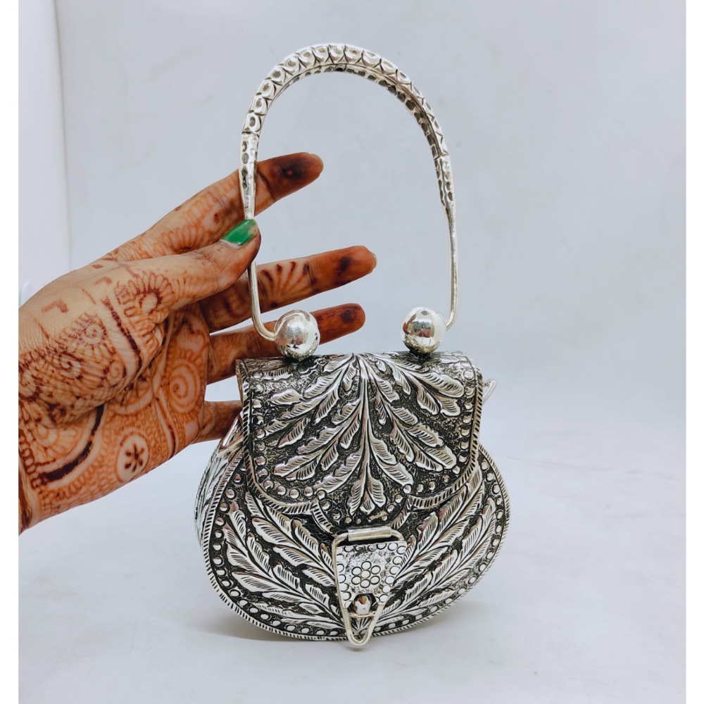 Pure silver hand bag in fine carvings and stud with designer handle