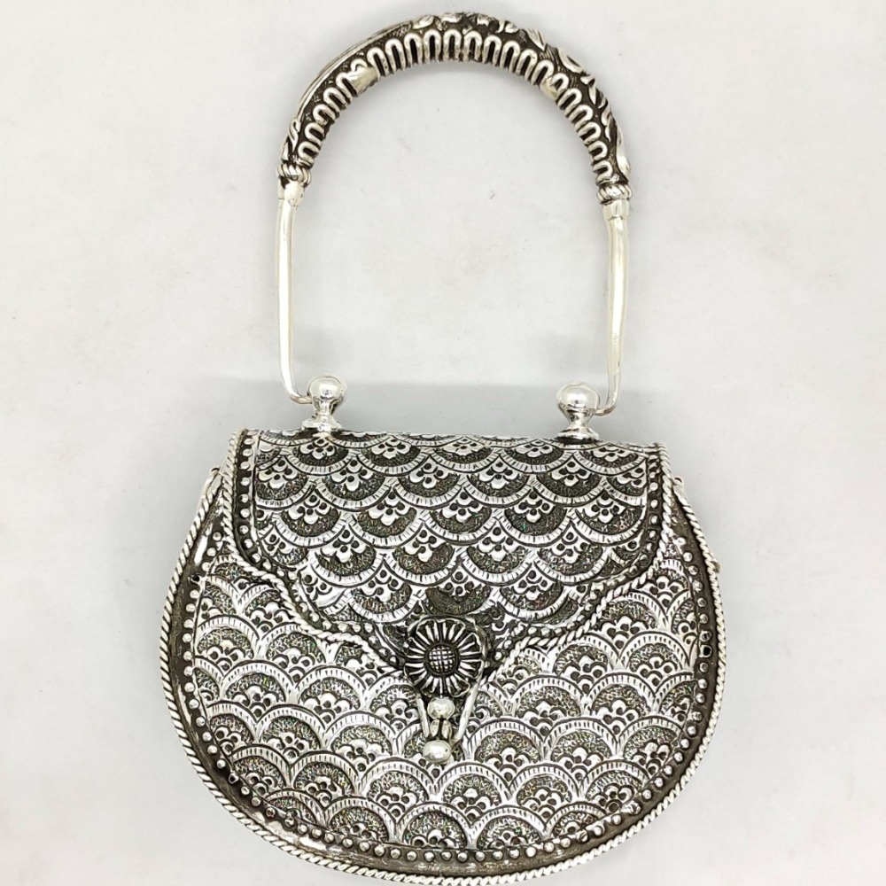Real silver hand bag in fine carvings and studded with handle