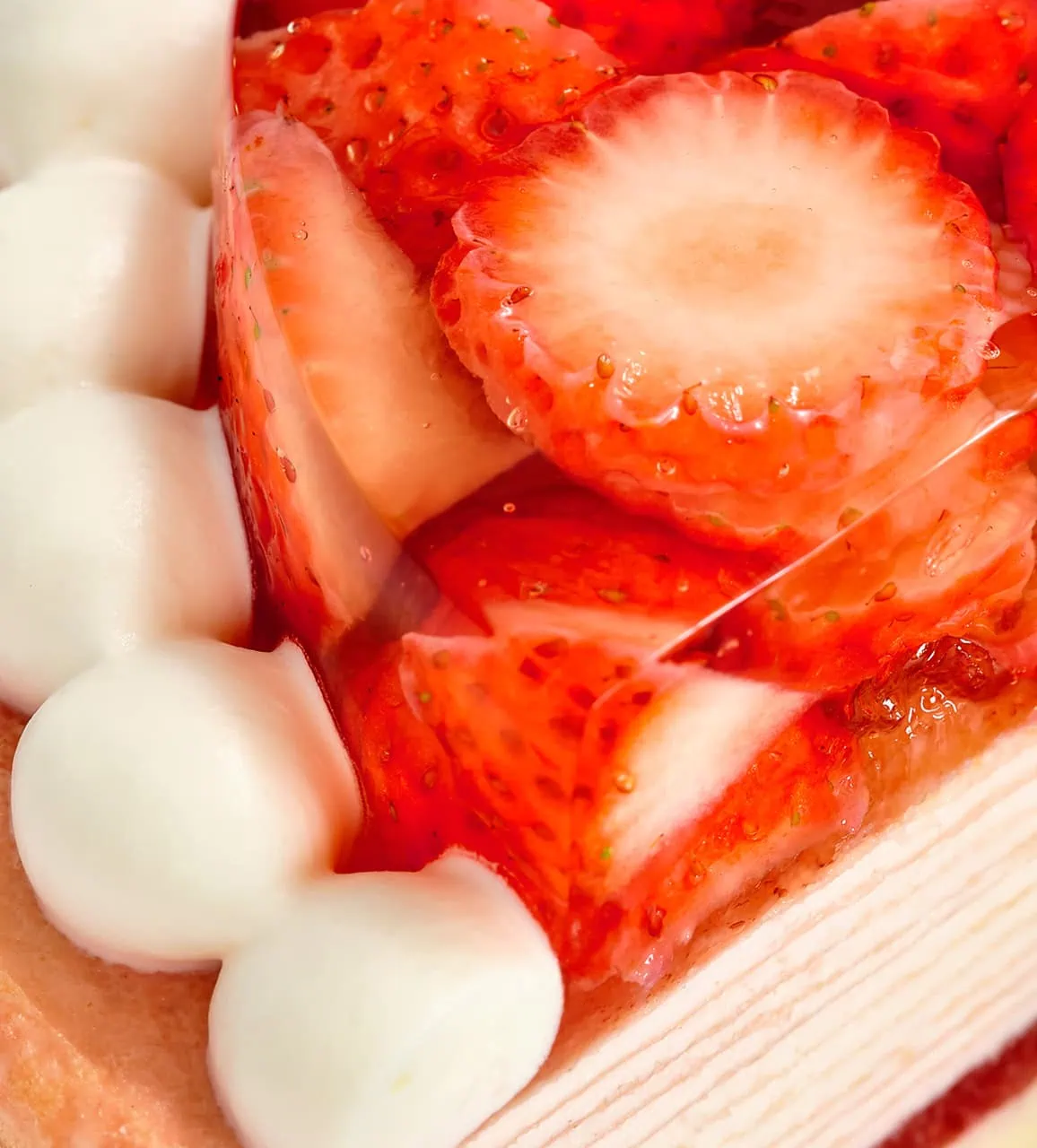 Oishii Berry Trois Mille Crêpes close up with slices of fresh strawberries and a layer of cream