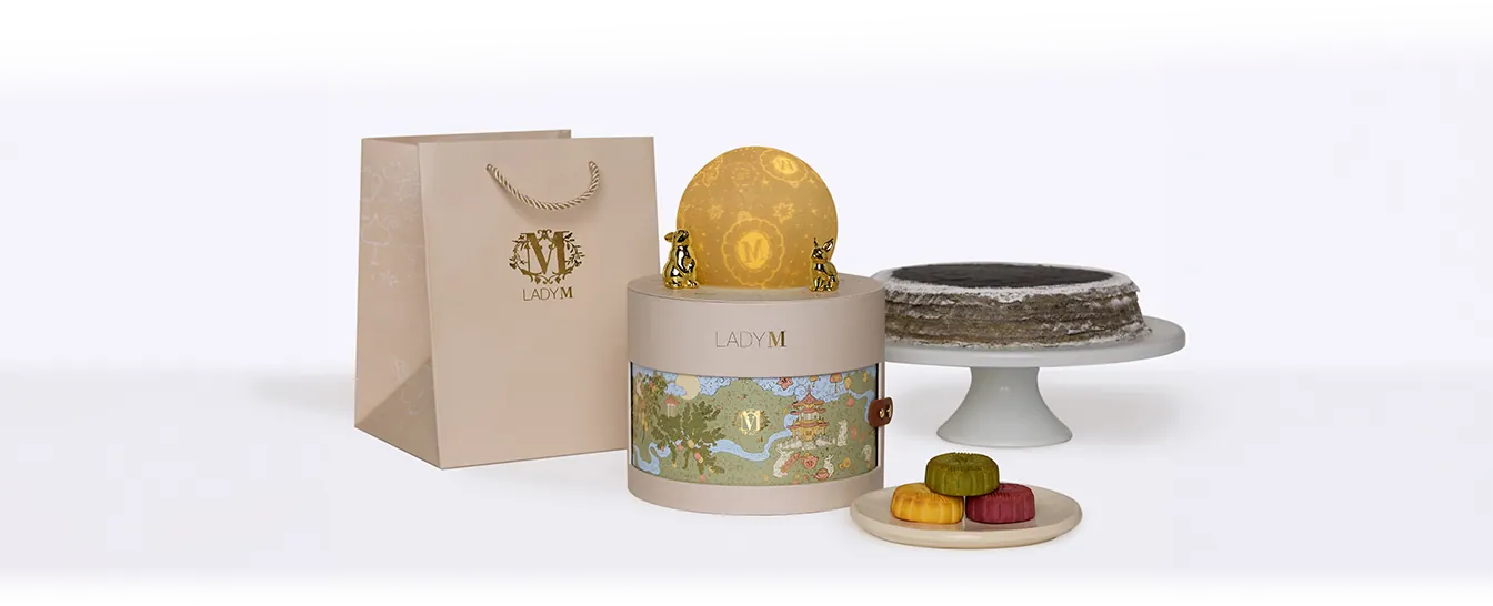 Moonlit Reverie gift set with gift bag, Sesame Mochi Crêpes cake, and mooncakes