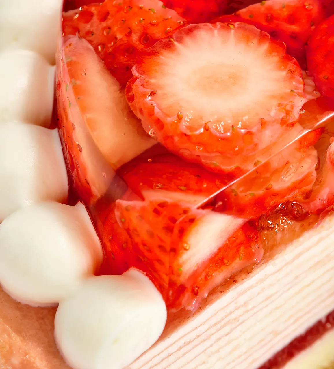 Oishii Berry Trois Mille Crêpes close up with slices of fresh strawberries and a layer of cream