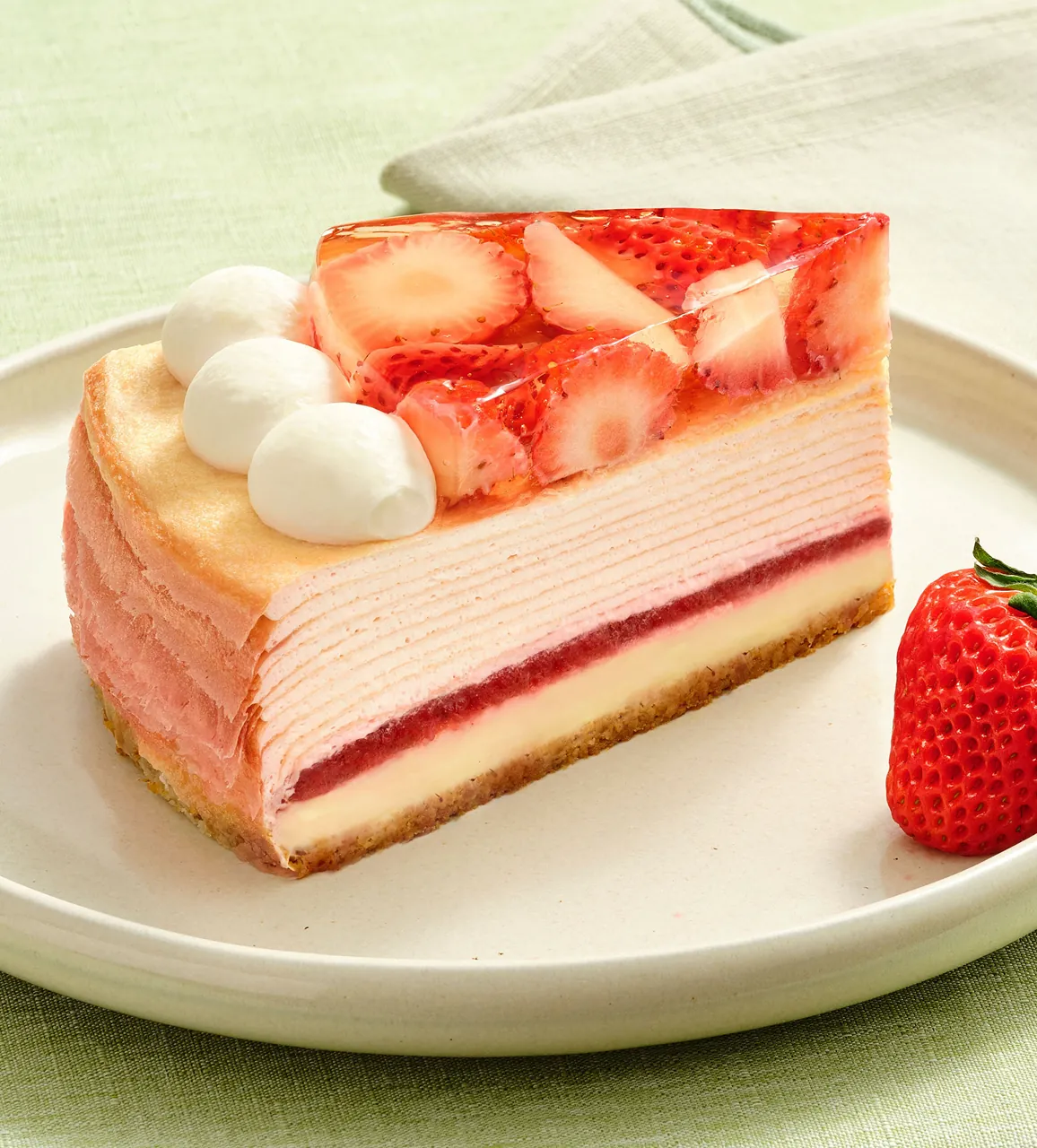 A single slice of Oishii Berry Trois Mille Crêpes on a plate