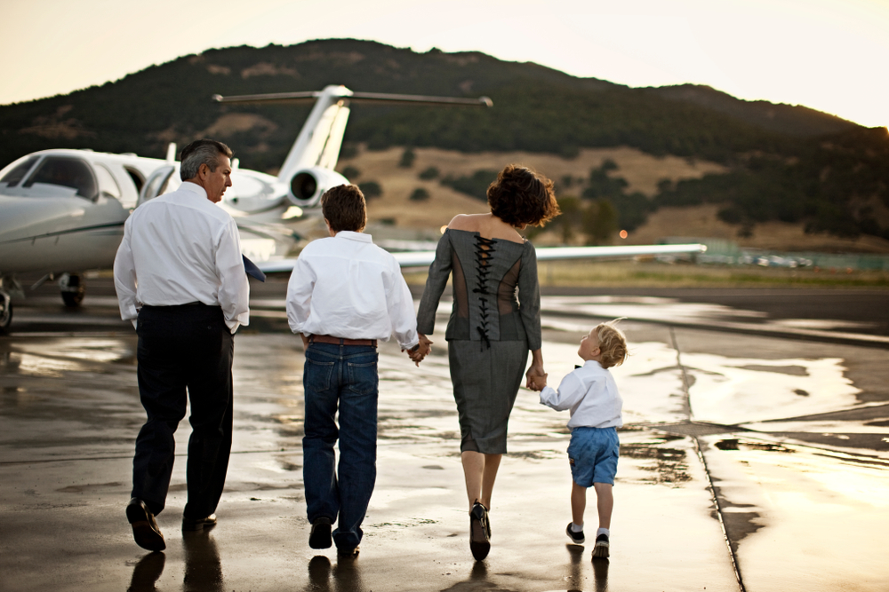 Family walking towards a private jet