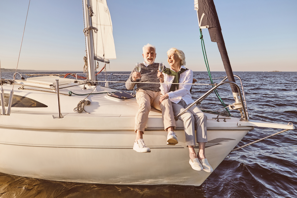 Senior couple sitting on the side of a boat