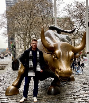 Bryan in front of a gold Bull