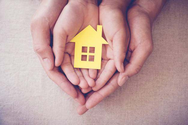 adult-child-hands-holding-yellow-house-family-home-homeless-shelter-concept_49149-543.jpg