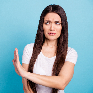 Woman Holding Hand Up to Reject Something