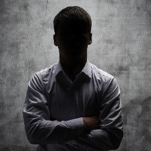 Image of a Mysterious Businessman With His Arms Crossed
