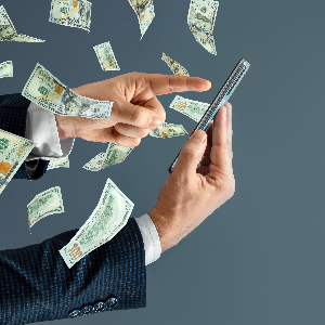 Image of Money Flying Out of a Businessman's Phone