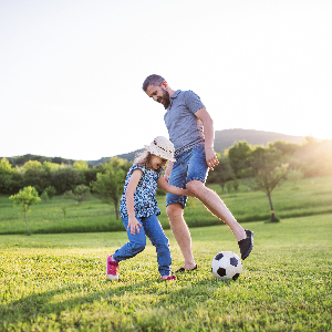 Image of a Father and Daughter Playing Soccer