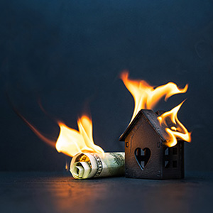 Image of money and a house burning