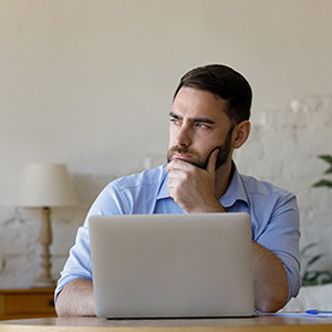Image of an investor looking off in thought
