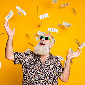 Image of a bearded man playing in raining cash