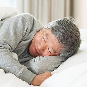 Image of an older investor sleeping blissfully