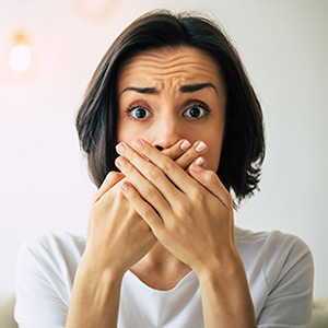 Image of a woman covering her mouth