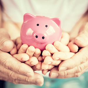 Image of hands holding a piggybank