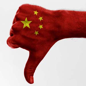 Image of a hand colored to look like the Chinese flag and giving a thumbs-down