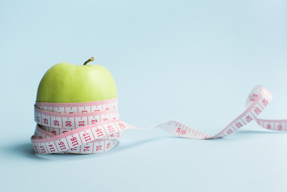 Apple with measuring tape