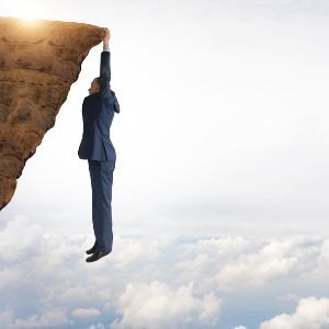 Man Hanging on Cliff