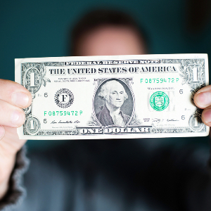 Man Holding Dollar Bill