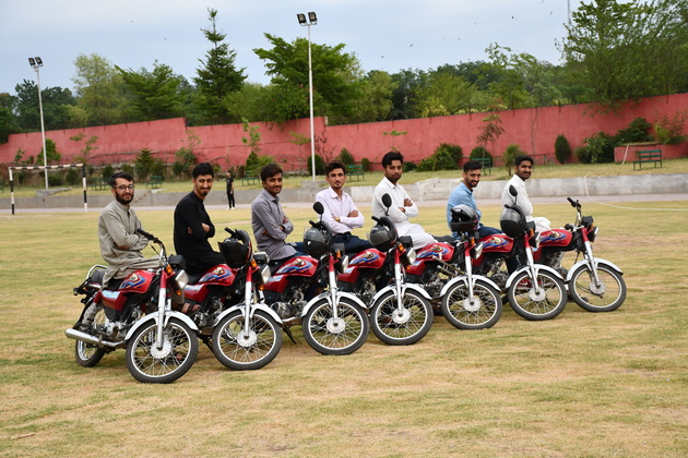 Uni students giving pose on their newly bike at PSH 