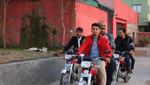 Uni students enjoying their first ride on motorbike with Papa Jani