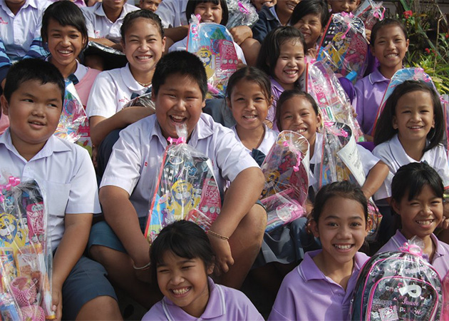 Children smiling holding gift baskets