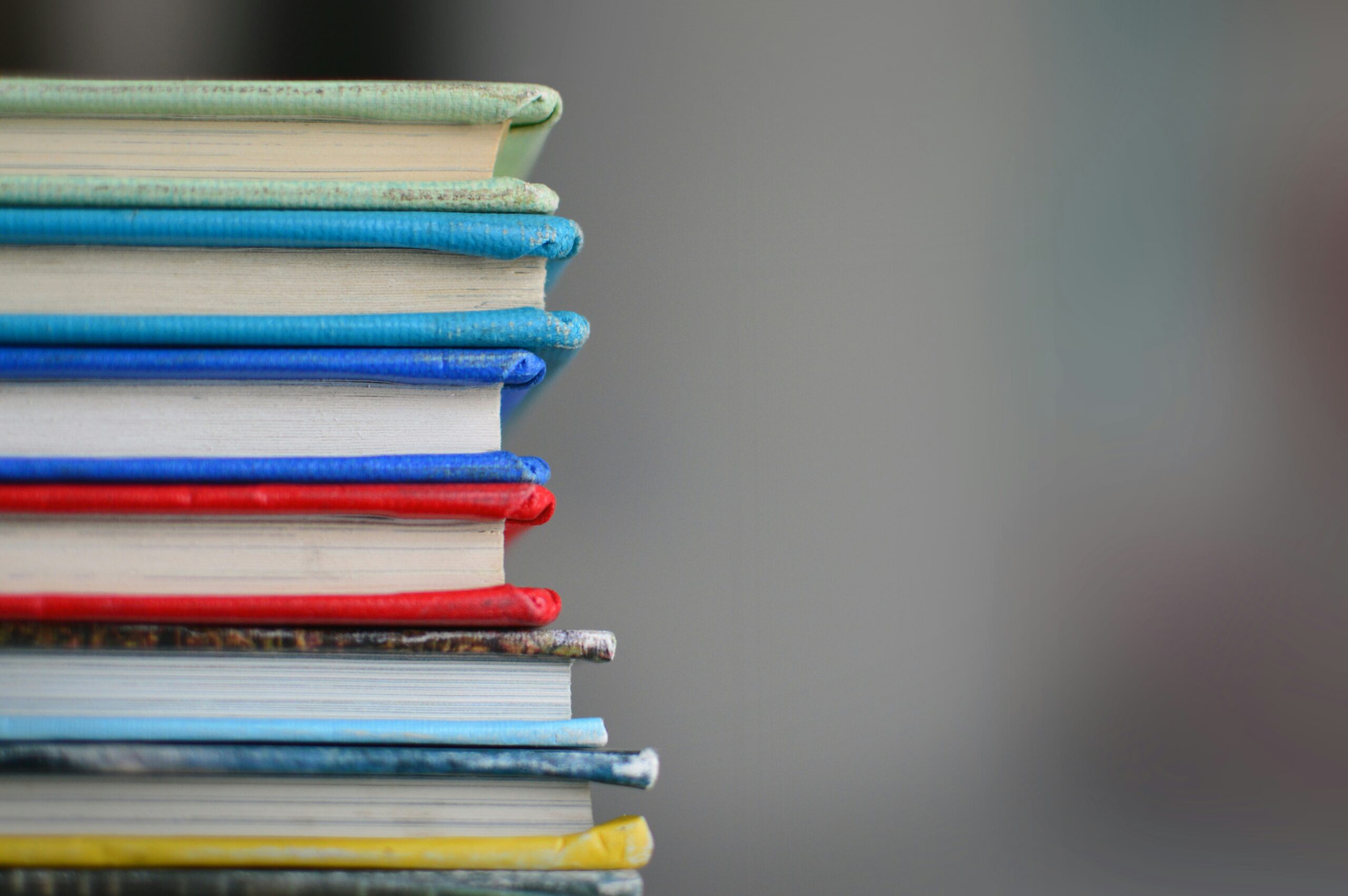 Stack of different colored books.