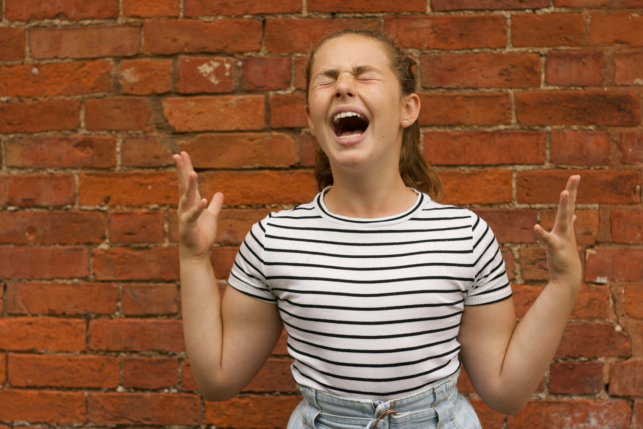 Young woman screaming.
