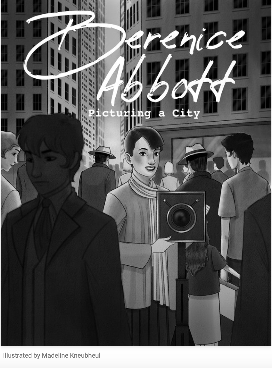 A gray-and-white illustration depicts a bustling cityscape. A young woman with short dark hair, big eyes, and a bright smile stands behind a large camera on a tripod. Around her is a street filled with people all going in different directions with tall buildings rising above them. At the top of the page, text reads, “Berenice Abbott: Picturing a City.”