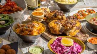 This is a photo of Cocotte's french rotisserie chicken on a sunny terrace.