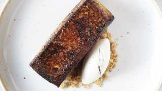 This is a photo of a buttery pain perdu and vanilla ice cream.