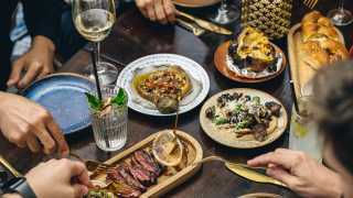 This is a colour image of a dining table at Pascor, Kensington