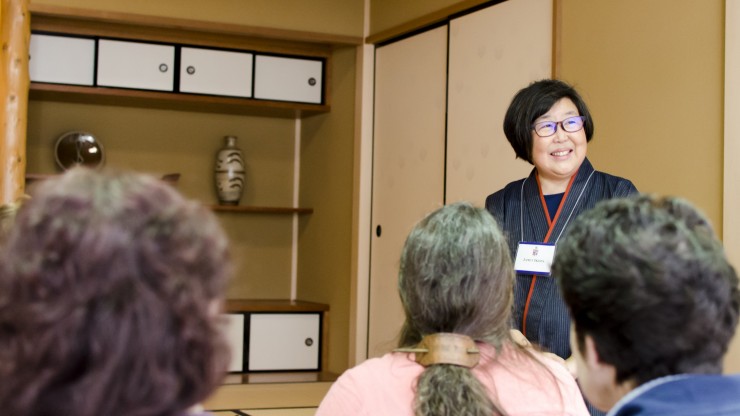 Teachers listen in as Janet Ikeda, Associate Professor of Japanese, explains the Japanese tea ceremony.