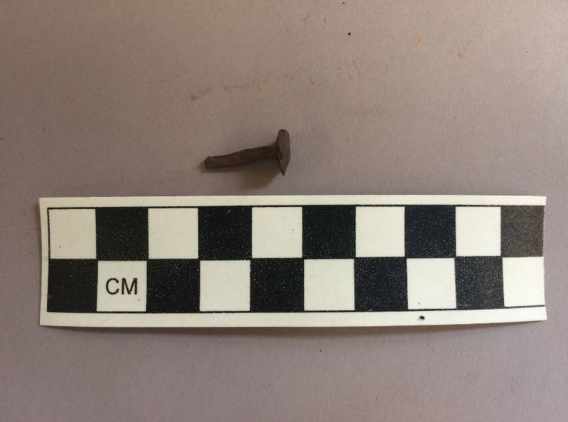 Here we can see the remnant of a small, used rose-head nail, bent out of shape from being pounded into the hard, native woods of New England.