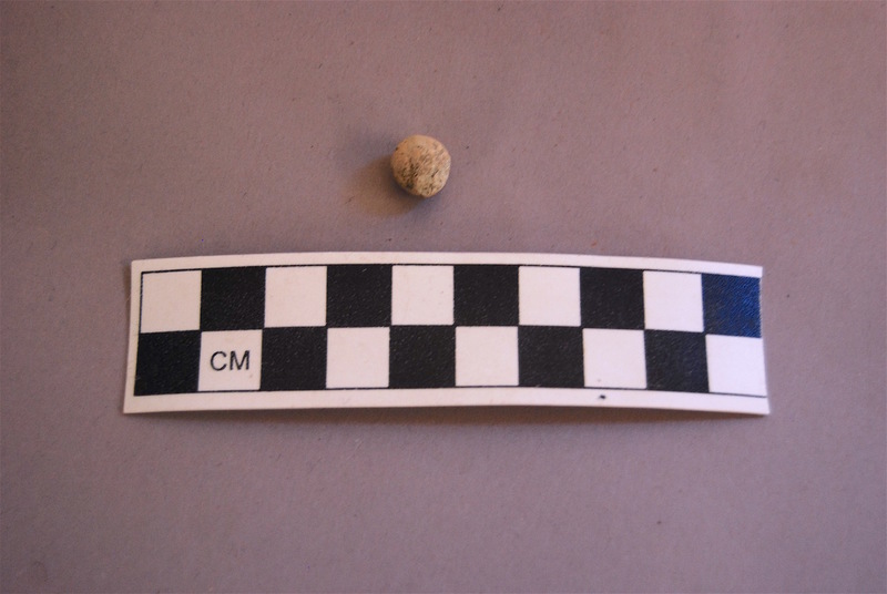The light color of this musket ball is due to a natural buildup of lead carbonates, sulfides and oxides over time, which helps confirm its age and material composition.