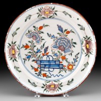 Tin-glazed earthenware plate. Although the sherd shows no evidence colorful glaze, many tin-glazed earthenware plates were decorated with elaborate designs, increasing their value.