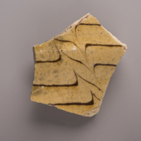 Sherd of North Midlands/Staffordshire-type slipware from the “House for Families” at George Washington’s Mount Vernon Estate. Sherd is from a dish or plate.