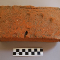Seventeenth-century red clay brick that was likely used in the original construction of the chimneys or cellar floor of the Old College (begun 1638, completed 1643).