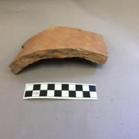 Profile view of roof tile, showing curvature and clay inclusions. This tile was unlike other popular, flat tiles, giving the Harvard building it roofed a unique visual appeal (Hume 1970, 294).