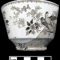 Brown transferware cup from Maryland. Bat printing worked well for irregularly shaped and small vessels since the bat easily fit along tight surfaces, meaning the sherd could have been something like a teacup or lid.
